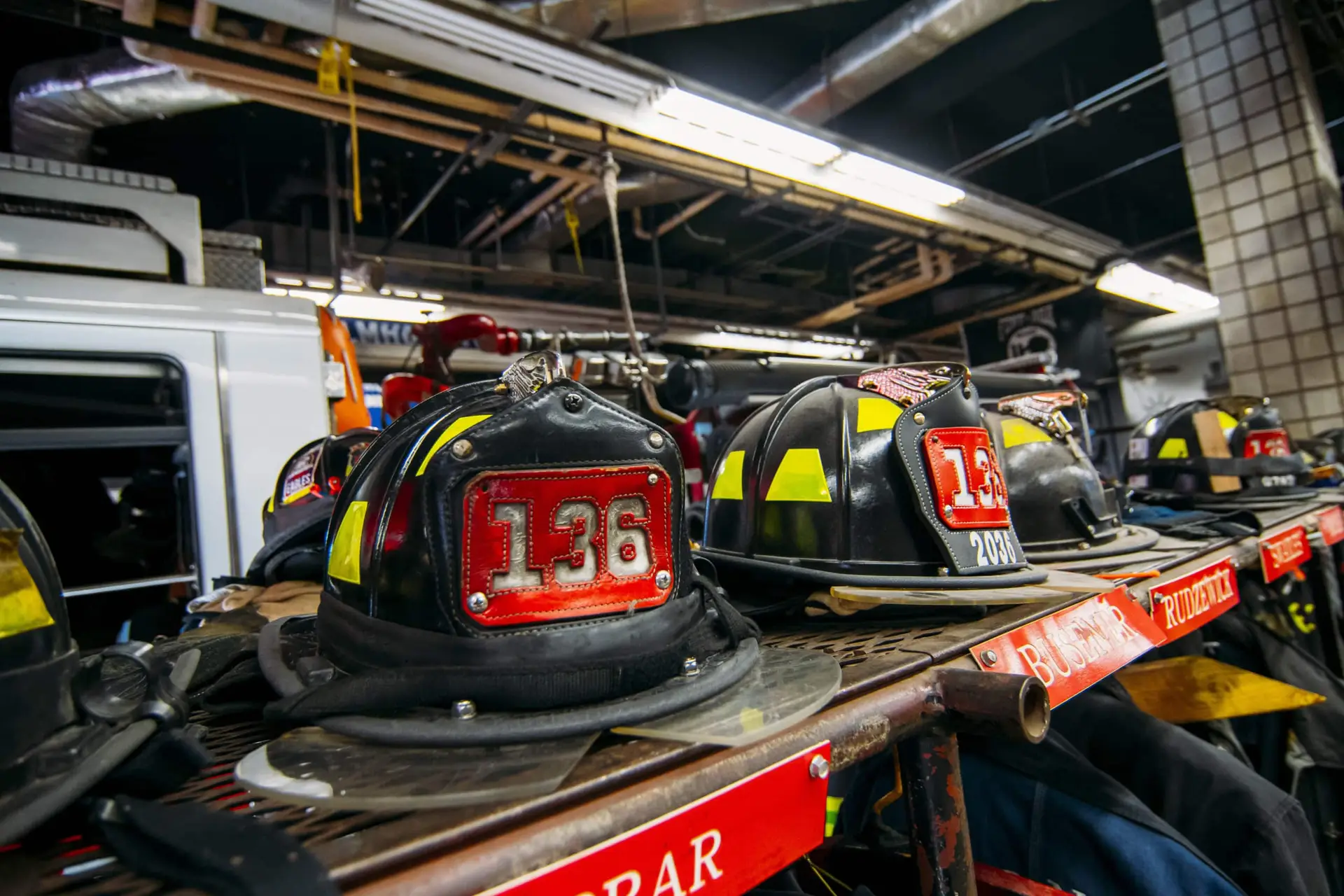 Firefighter helmets and gear neatly arranged and ready for action at a fire station.
